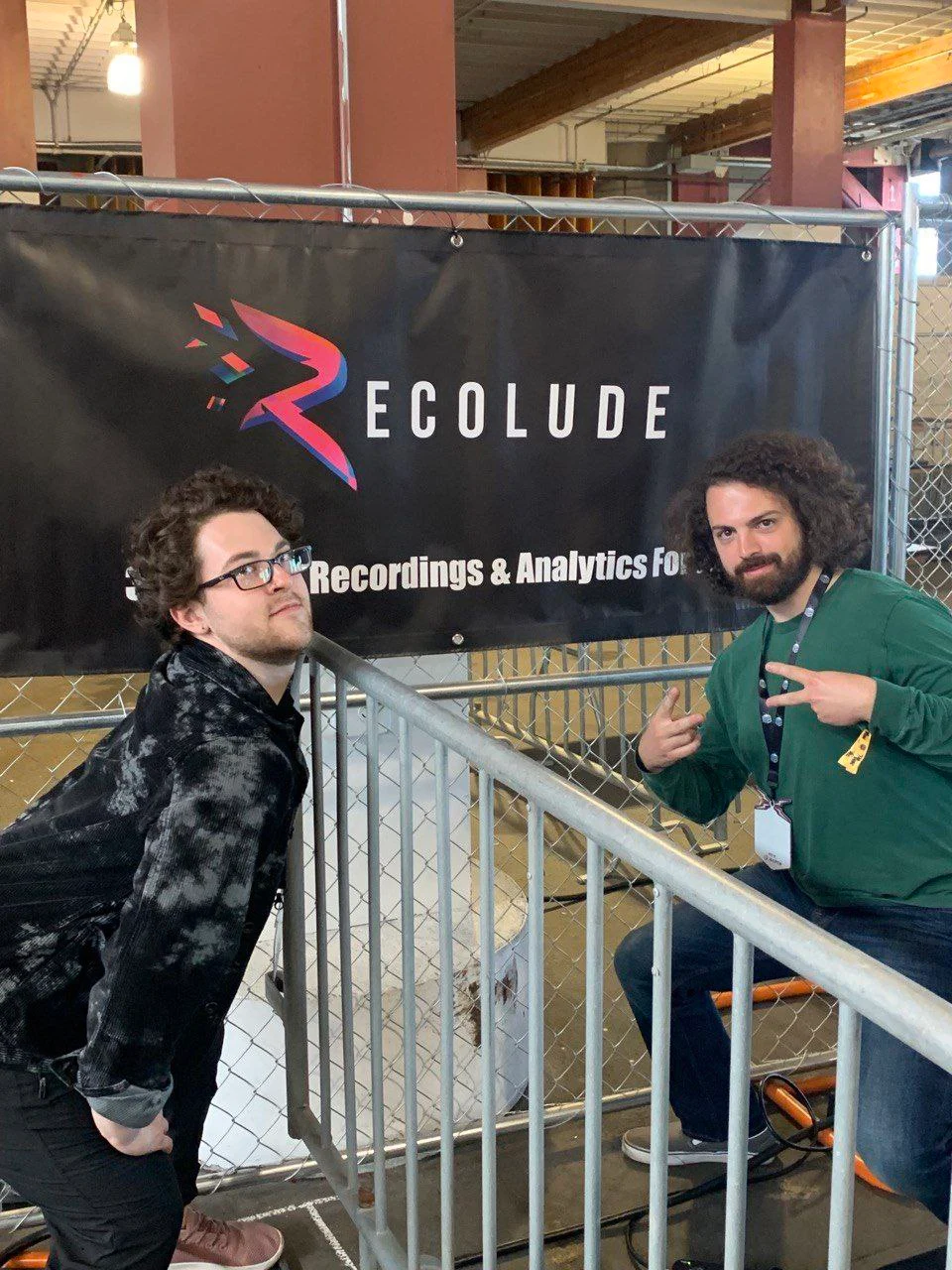 Recolude founders posing in front of their banner at Open Sauce